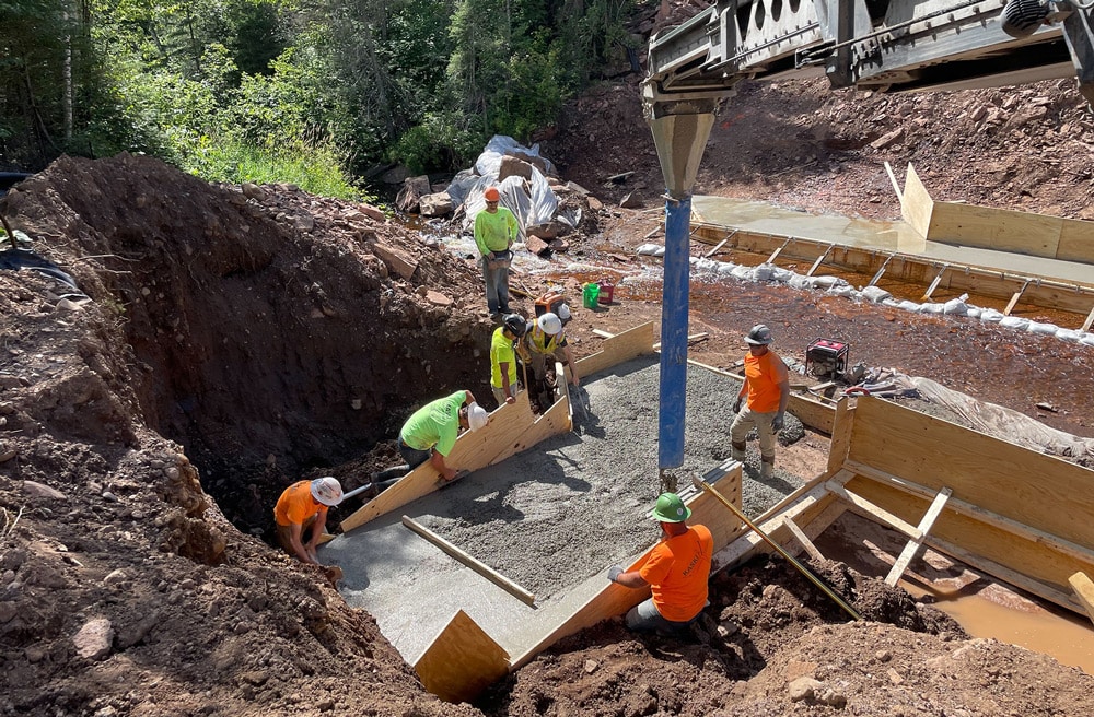 Construction team pouring concrete